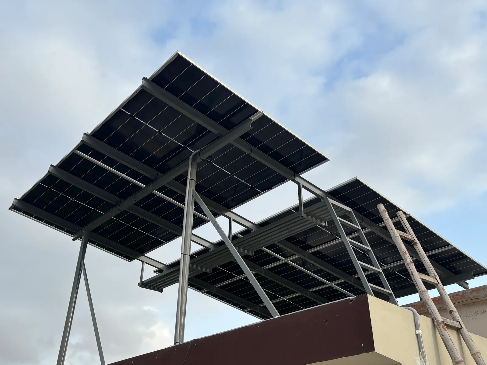 Stepped two-level elevated solar array by APC Solar on a compact Karachi rooftop
