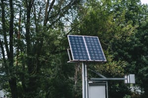 solar-battery-panel-in-the-city-park-near-the-tree